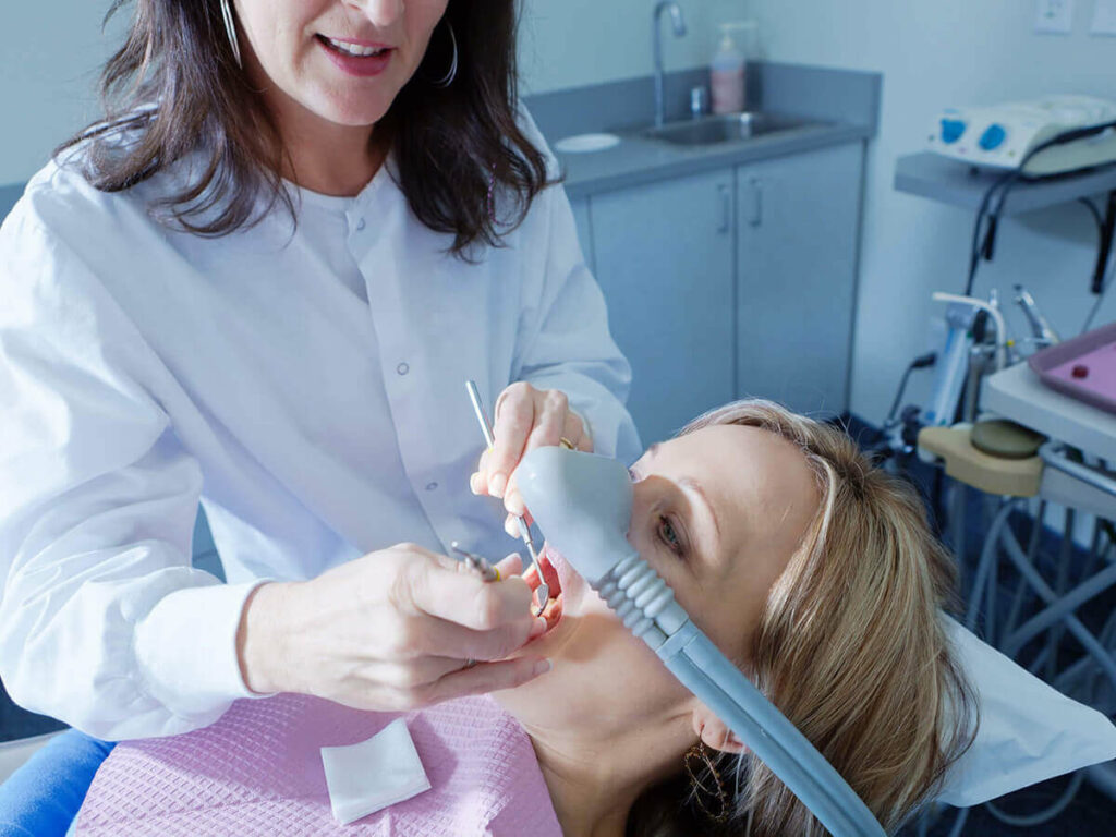 woman under dental sedation receiving dental work